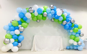 Blue white and green balloon arch
