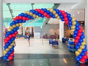 Large red blue and gold balloon arch
