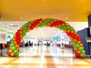 Large red gold and green balloon arch decor