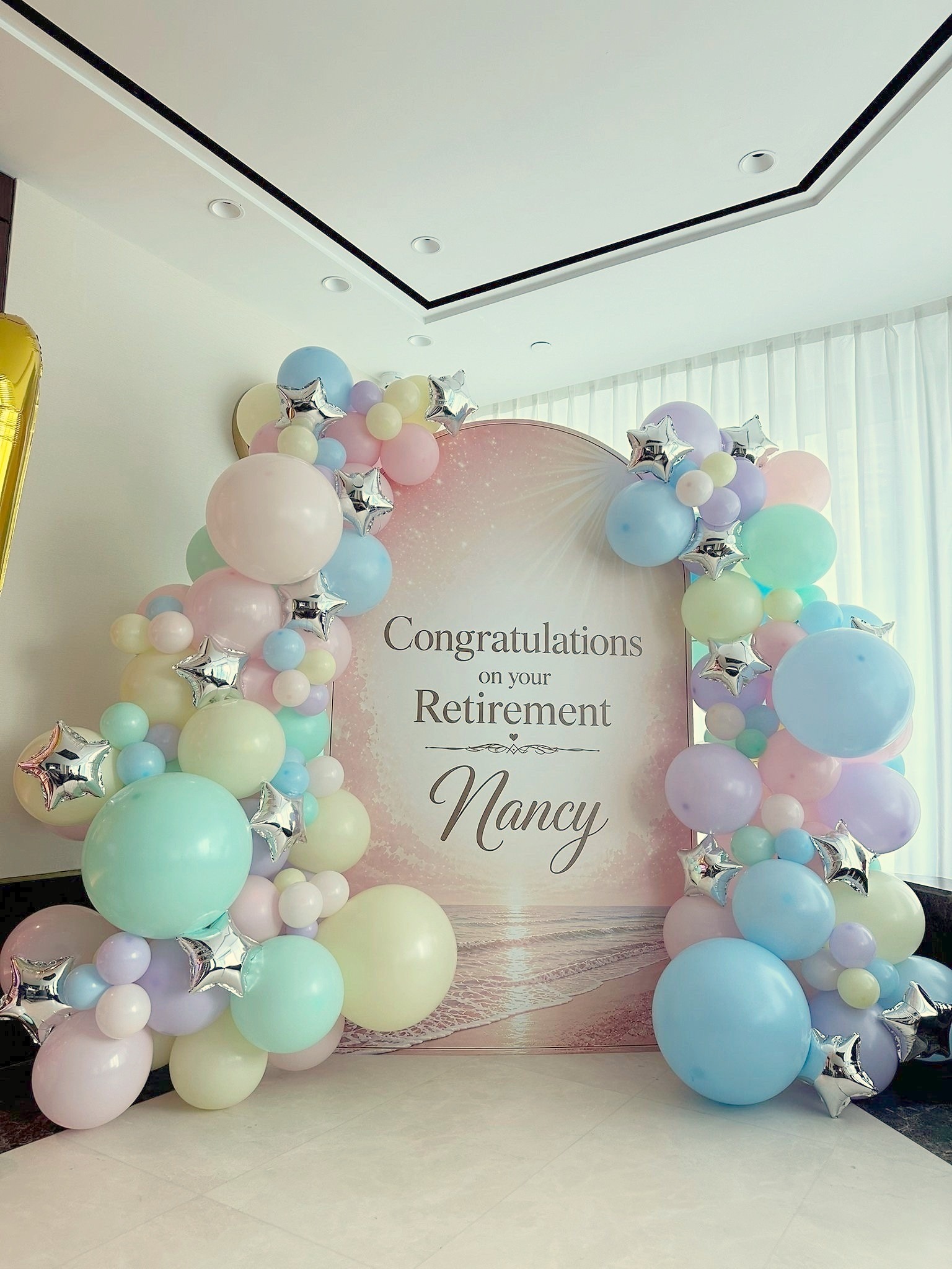 Balloon Backdrop: 6 Easy Ways to Keep Your Event Message Clear 5 Pastel balloon garland framing a personalised retirement message